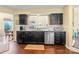 Modern kitchen with black cabinets, stainless steel appliances, and granite countertops at 13733 Castleford Dr, Mint Hill, NC 28227