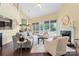 Bright living room with fireplace, large windows, and hardwood floors at 13733 Castleford Dr, Mint Hill, NC 28227