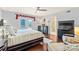 Inviting primary bedroom with pool access, dark wood floors, and a ceiling fan at 13733 Castleford Dr, Mint Hill, NC 28227
