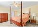 Main bedroom with four-poster bed, carpet, dresser, and a nightstand at 13733 Castleford Dr, Mint Hill, NC 28227