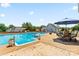 Inviting pool area with a hot tub, patio furniture, and well-maintained surroundings at 13733 Castleford Dr, Mint Hill, NC 28227