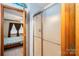 A full bathroom is adjacent to a bedroom with tile flooring and natural light at 1553 Home Trl # 51, Lincolnton, NC 28092