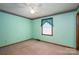 Carpeted bedroom featuring a ceiling fan, small window, and light green walls with decorative trim at 1553 Home Trl # 51, Lincolnton, NC 28092