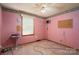 Pink bedroom featuring a ceiling fan and window, with carpeting and decorative trim around the walls at 1553 Home Trl # 51, Lincolnton, NC 28092