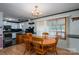 A charming dining room features a wood table, natural light and an elegant chandelier at 1553 Home Trl # 51, Lincolnton, NC 28092