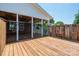 Exterior view showcasing a covered porch with swings, ceiling fans, and secure fencing leading to a deck at 1553 Home Trl # 51, Lincolnton, NC 28092