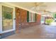 Cozy front porch featuring ceiling fans, brick accents, and a welcoming entrance door at 1553 Home Trl # 51, Lincolnton, NC 28092