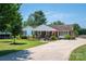 Charming brick home featuring manicured landscaping, long driveway, and inviting front porch perfect for relaxing at 1553 Home Trl # 51, Lincolnton, NC 28092
