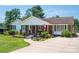 Charming brick home featuring mature trees, well-kept landscaping, and a welcoming front porch perfect for relaxing at 1553 Home Trl # 51, Lincolnton, NC 28092