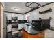 Well-lit kitchen with white cabinetry, black countertops, and stainless steel appliances at 1553 Home Trl # 51, Lincolnton, NC 28092