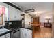 Open kitchen with dining area featuring black countertops, white cabinets, and wooden furniture at 1553 Home Trl # 51, Lincolnton, NC 28092