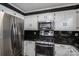 Kitchen with stainless steel appliances, dark backsplash and white cabinets at 1553 Home Trl # 51, Lincolnton, NC 28092