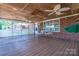 Covered porch with wood flooring, ceiling fans, swings, and secure fencing, ideal for outdoor entertainment at 1553 Home Trl # 51, Lincolnton, NC 28092