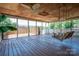 Covered porch featuring wood flooring, ceiling fans, and a swing, offering a cozy outdoor space at 1553 Home Trl # 51, Lincolnton, NC 28092