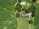 Aerial view showcases the home's placement on a large lot with surrounding trees and farmland at 1904 Old Peachland Rd, Marshville, NC 28103