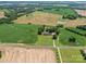 Aerial view showcasing the home nestled among green fields and trees with a small pond nearby at 1904 Old Peachland Rd, Marshville, NC 28103