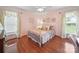 Comfortable bedroom with bright light from two windows and classic hardwood flooring throughout at 1904 Old Peachland Rd, Marshville, NC 28103