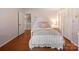 Cozy bedroom with hardwood floors and soft pastel decor, complete with ample closet space at 1904 Old Peachland Rd, Marshville, NC 28103