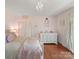 Pink themed bedroom with wooden floors, ample storage, and closet at 1904 Old Peachland Rd, Marshville, NC 28103