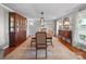 Formal dining room showcasing wood floors, large cabinet, and a stylish chandelier at 1904 Old Peachland Rd, Marshville, NC 28103