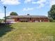 Charming home features an attached garage and lush green lawn at 1904 Old Peachland Rd, Marshville, NC 28103