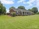 The exterior of this charming home features a well-manicured lawn and mature landscaping at 1904 Old Peachland Rd, Marshville, NC 28103