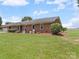 The exterior of this charming home features a well-manicured lawn and mature landscaping at 1904 Old Peachland Rd, Marshville, NC 28103