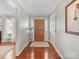 Inviting foyer with hardwood floors, featuring a wooden front door and elegant decor at 1904 Old Peachland Rd, Marshville, NC 28103
