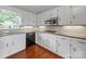 Modern kitchen featuring white cabinets, stainless steel appliances, and hardwood floors at 1904 Old Peachland Rd, Marshville, NC 28103