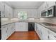 Well-lit kitchen with white cabinets, granite countertops, and stainless steel appliances at 1904 Old Peachland Rd, Marshville, NC 28103