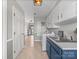 Hallway view of the laundry room with modern white cabinets, blue sink, and Maytag washer and dryer at 1904 Old Peachland Rd, Marshville, NC 28103