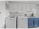 Bright laundry room with white cabinets, sink, and modern Maytag washer and dryer at 1904 Old Peachland Rd, Marshville, NC 28103