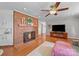 Living room featuring a brick fireplace, hardwood floors, and a ceiling fan at 1904 Old Peachland Rd, Marshville, NC 28103