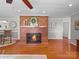 Cozy living room featuring a brick fireplace and hardwood floors, perfect for relaxing at 1904 Old Peachland Rd, Marshville, NC 28103