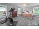 Main bedroom with bike, dresser, windows, and ceiling fan; ideal for fitness at 1904 Old Peachland Rd, Marshville, NC 28103