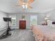 Main bedroom featuring a dresser, bike, windows, and ceiling fan at 1904 Old Peachland Rd, Marshville, NC 28103