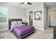 Well-lit bedroom features a ceiling fan, and window with shutters at 200 Squash Harvest Ct, Matthews, NC 28104