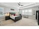 Bright bedroom with a ceiling fan, window with shutters, carpeted floor, and a modern bed at 200 Squash Harvest Ct, Matthews, NC 28104