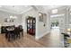 A formal dining room with modern chandelier and views of a covered patio at 200 Squash Harvest Ct, Matthews, NC 28104