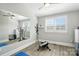 Bright exercise room featuring neutral walls, wood-look floors, and a large mirror, ready for a home gym setup at 200 Squash Harvest Ct, Matthews, NC 28104