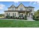 A charming two-story brick home with a lush green lawn and well-maintained landscaping at 200 Squash Harvest Ct, Matthews, NC 28104