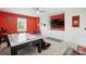 The game room with air hockey, tv, and seating features NC State decor at 200 Squash Harvest Ct, Matthews, NC 28104