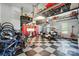 Well-organized garage with checkered floors, overhead storage racks, tool cabinets, and a golf cart at 200 Squash Harvest Ct, Matthews, NC 28104