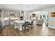 Kitchen and breakfast bar open to the living room with fireplace at 200 Squash Harvest Ct, Matthews, NC 28104