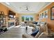 Bright living room boasts fireplace, ceiling fan, hardwood floors and a comfortable, modern sectional at 200 Squash Harvest Ct, Matthews, NC 28104