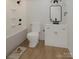 Modern bathroom with white cabinets, sleek fixtures, and a tub shower at 2063 Sadler Woods Ln, Charlotte, NC 28214
