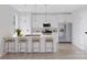 Modern kitchen with white cabinets, stainless steel appliances, and a quartz countertop island at 2063 Sadler Woods Ln, Charlotte, NC 28214