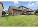 Expansive backyard featuring a lush lawn and a charming pergola-covered deck at 2377 Maple Grove Nw Ln, Concord, NC 28027