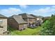 View of the home's backyard, featuring a lush lawn and covered patio area at 2377 Maple Grove Nw Ln, Concord, NC 28027