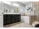 Modern bathroom featuring double sinks, a soaking tub, and a glass-enclosed shower at 2377 Maple Grove Nw Ln, Concord, NC 28027